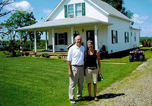 Gordon Peterson and daughter Shelly Strong in front of former Bloom home in East Swede Town