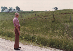 Ray Peterson, standing on the Monroe/Mahaska County Line