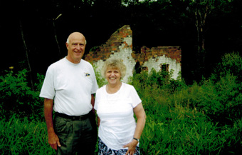 Gordon Peterson and Joan Lund in front of Peterson home ruins